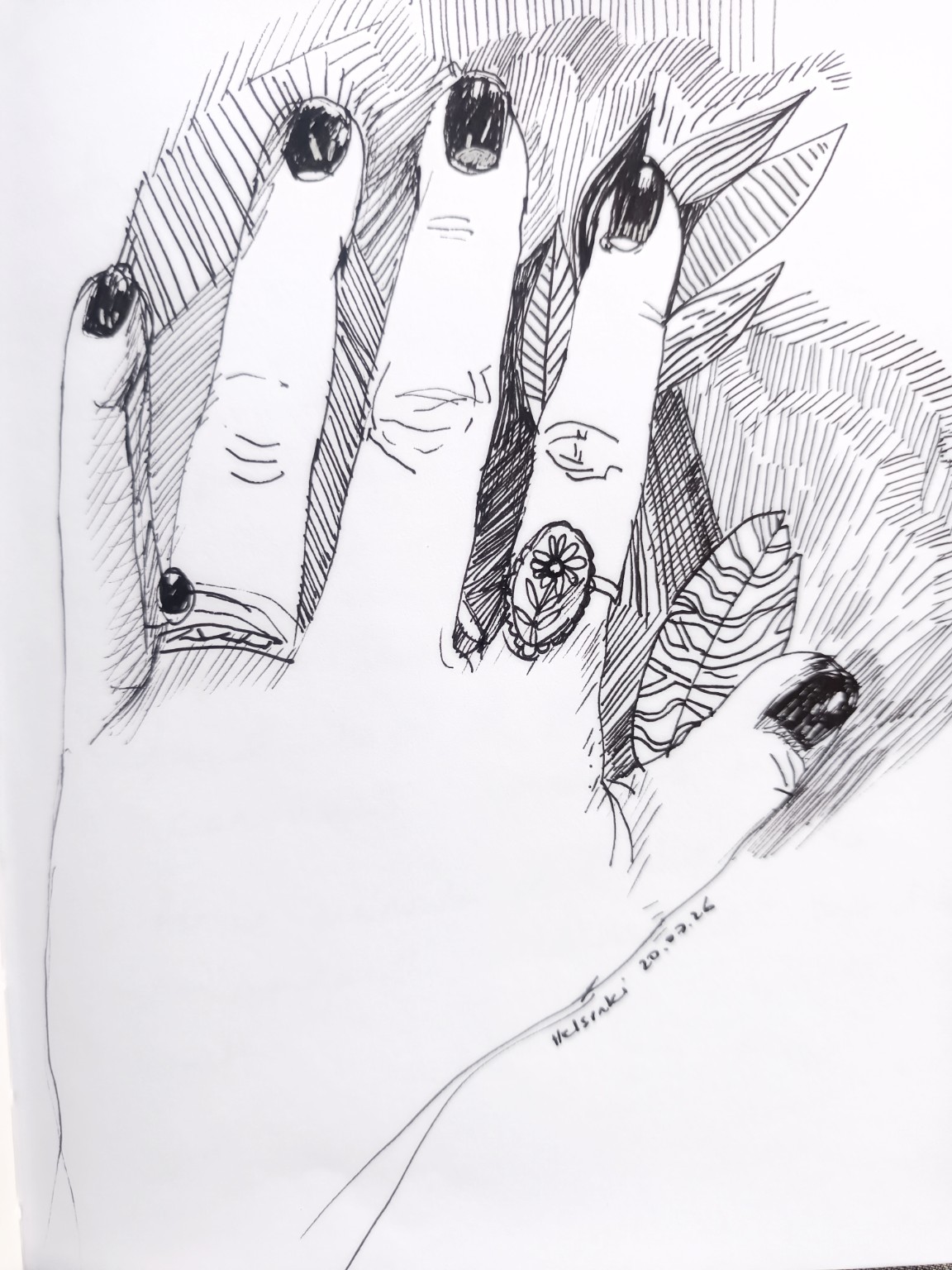 A black drawing of a hand with dark nails, rings and leaves against a patterned background.